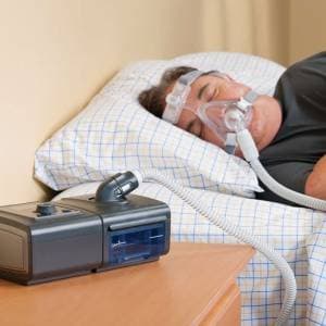 Bi-level positive airway pressure machine with integrated heated humidifier