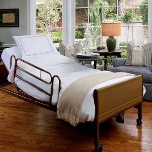 Manual hospital bed with adjustable backrest, side rails and locking castors
